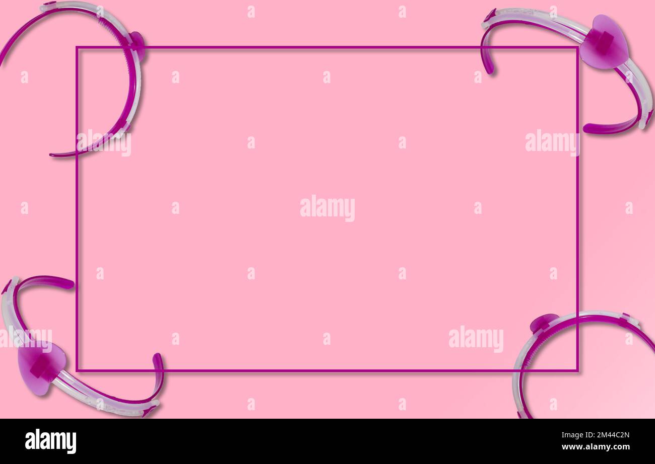 purple frame on the pink background, around frame purple head bands, creative holiday design, copy space Stock Photo