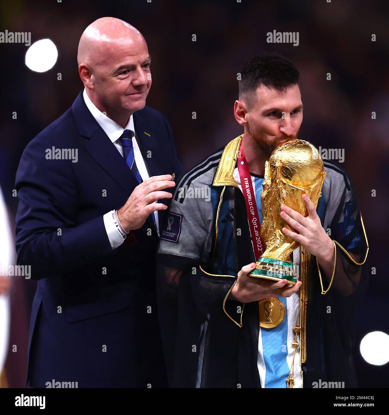 Lusail City, Qatar. 18th Dec, 2022. Lionel Messi of Argentina kisses the FIFA World Cup trophy as FIFA President Gianni Infantino looks on following the 2022 FIFA World Cup Final at Lusail Stadium in Lusail City, Qatar on December 18, 2022. Photo by Chris Brunskill/UPI Credit: UPI/Alamy Live News Stock Photo