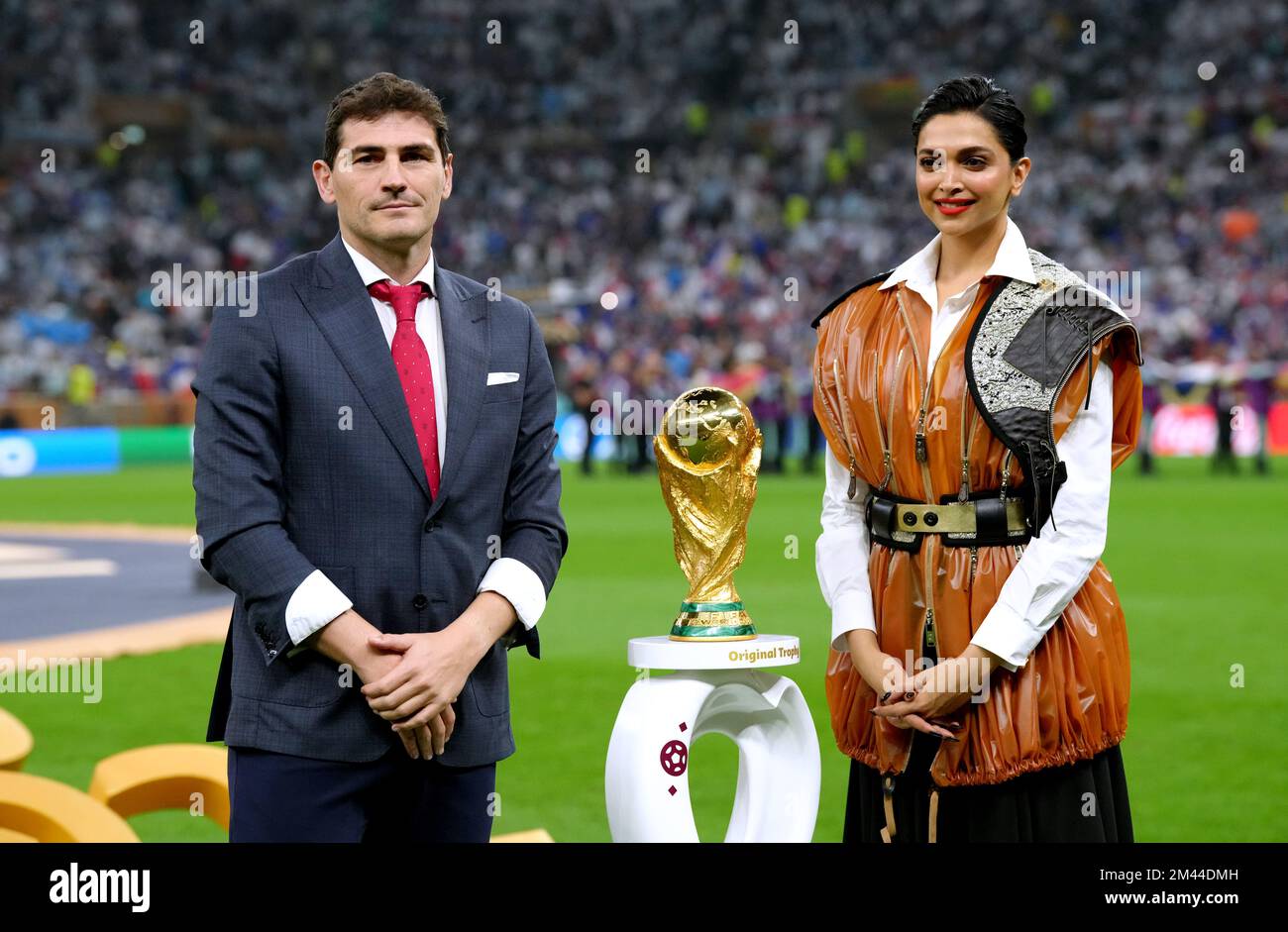 Former footballer Iker Casillas (left) and Deepika Padukone stand beside the FIFA World Cup trophy ahead of the FIFA World Cup final at Lusail Stadium, Qatar. Picture date: Sunday December 18, 2022. Stock Photo