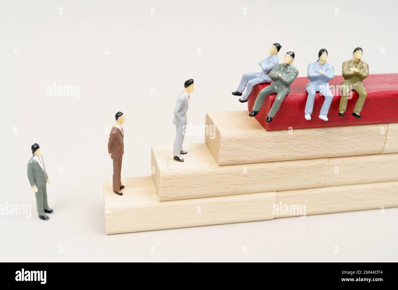 Corruption concept. Figures of people rise on wooden blocks. Figures of