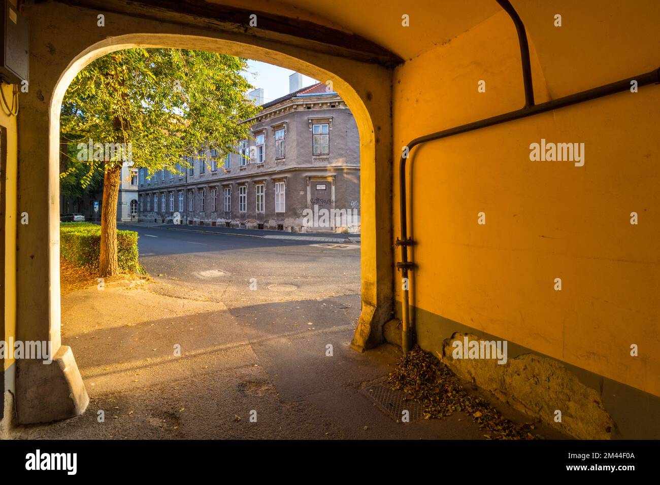Gateway in Rakoczi Ferenc utca in morning sun, Sopron, Hungary Stock Photo