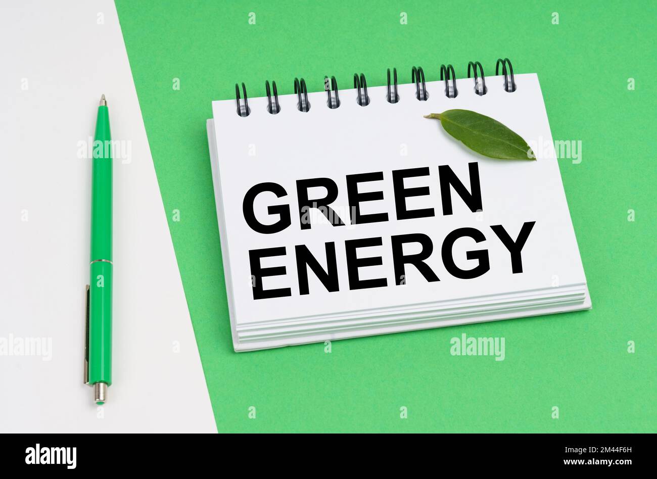 Ecological concept. On a white-green background lies a pen and a ...