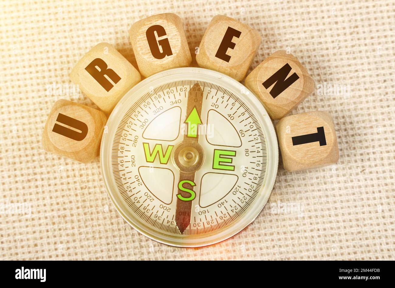 Business concept. On the table is a compass and cubes with the inscription - URGENT Stock Photo