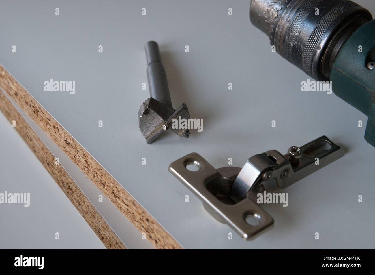 Tools for installation furniture fittings. hinge fixed on a modern