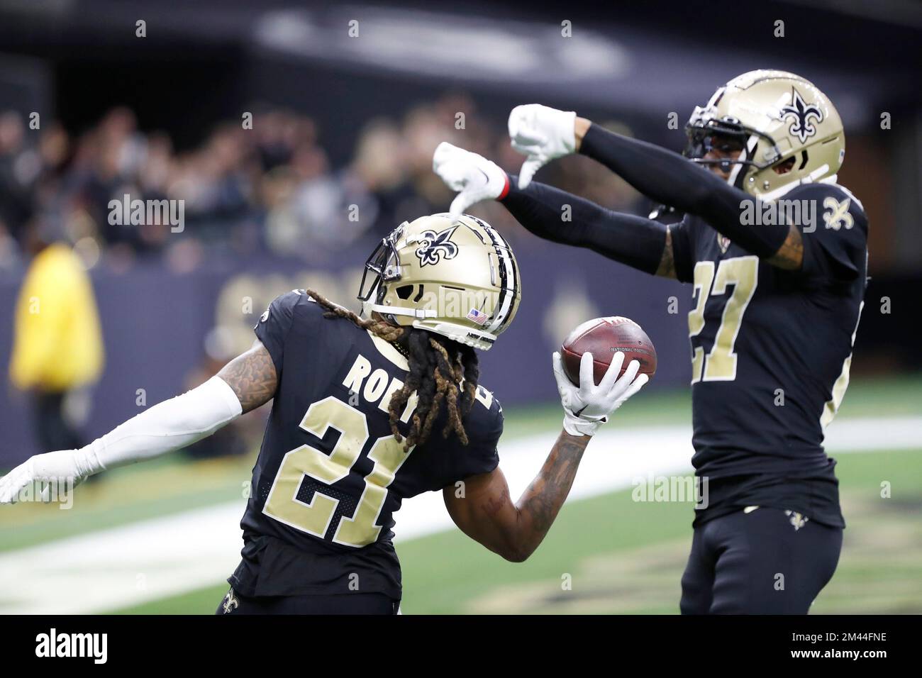 New Orleans, USA. 18th Dec, 2022. New Orleans Saints cornerback Bradley Roby (21) throws the ball into the stands while celebrating a recovered fumble with fellow cornerback Alontae Taylor (27) during a NFL contest at Caesars Superdome in New Orleans, Louisiana on Sunday, December 18, 2022. (Photo by Peter G. Forest/Sipa USA) Credit: Sipa USA/Alamy Live News Stock Photo