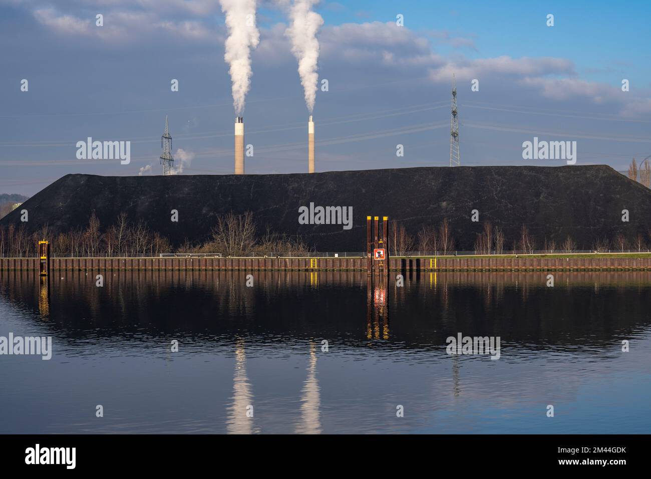 Coal dump, coal stockpile, power station coal, for the STEAG combined heat and power plant in Herne, in the background chimneys of AGR Abfallentsorgun Stock Photo