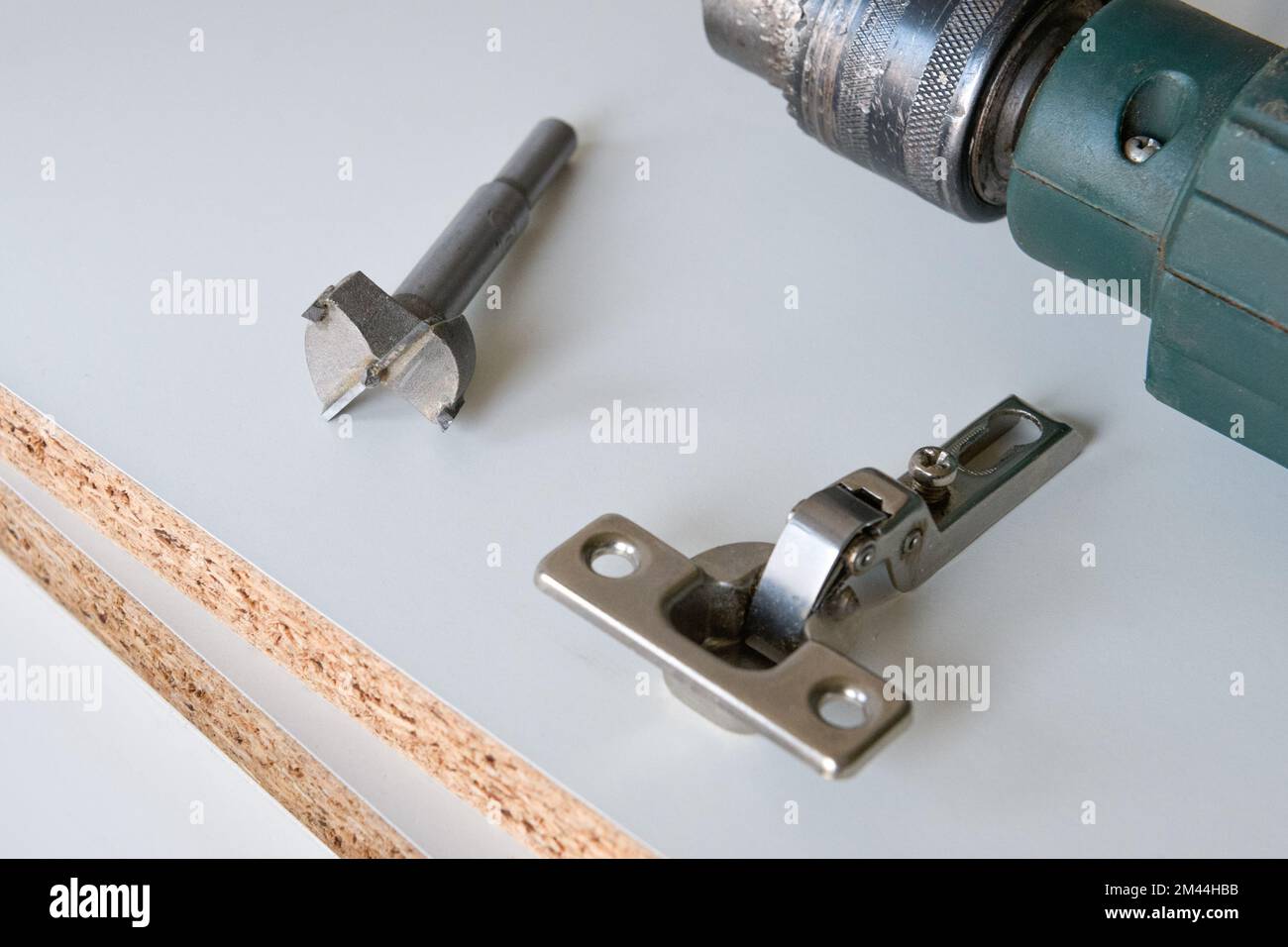 Installation furniture fittings. hinge fixed on a modern Stock