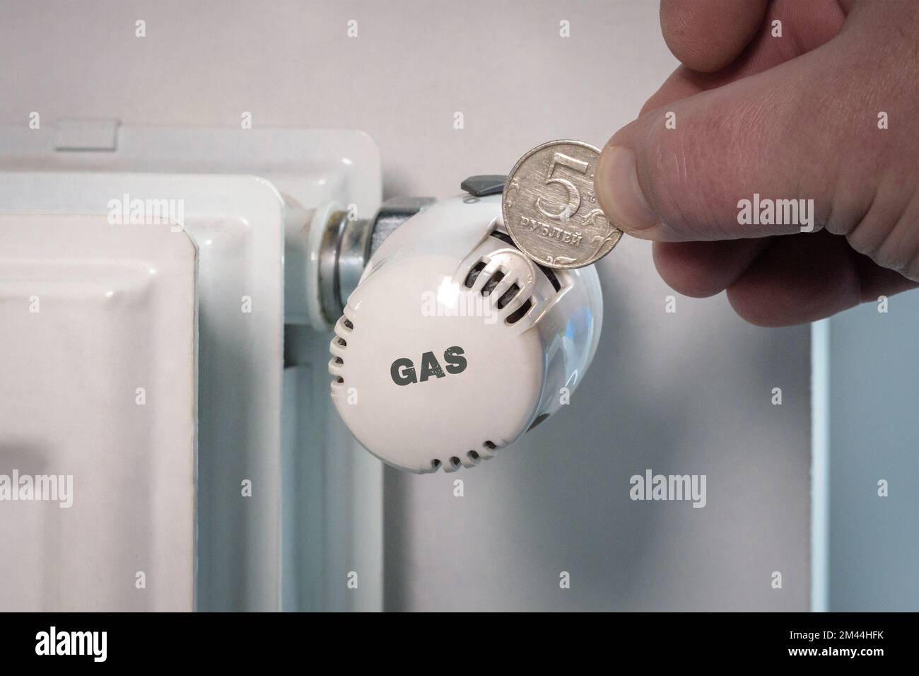 Ruble and gas. Image of a heating battery and five Russian rubles Stock Photo
