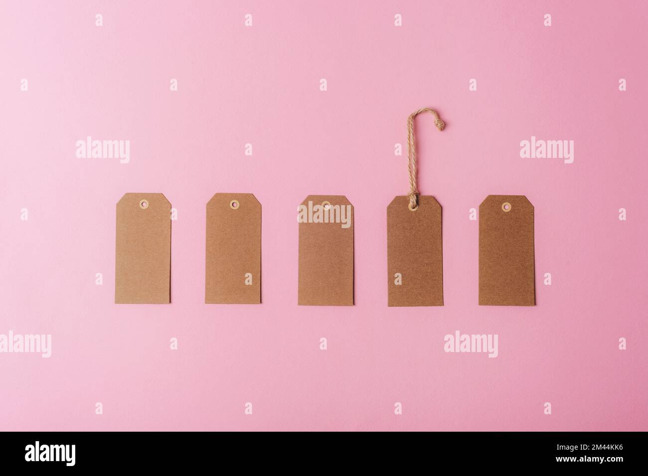 Brown kraft paper tags on pink background. Minimal flat lay. Top view, mockup Stock Photo Alamy