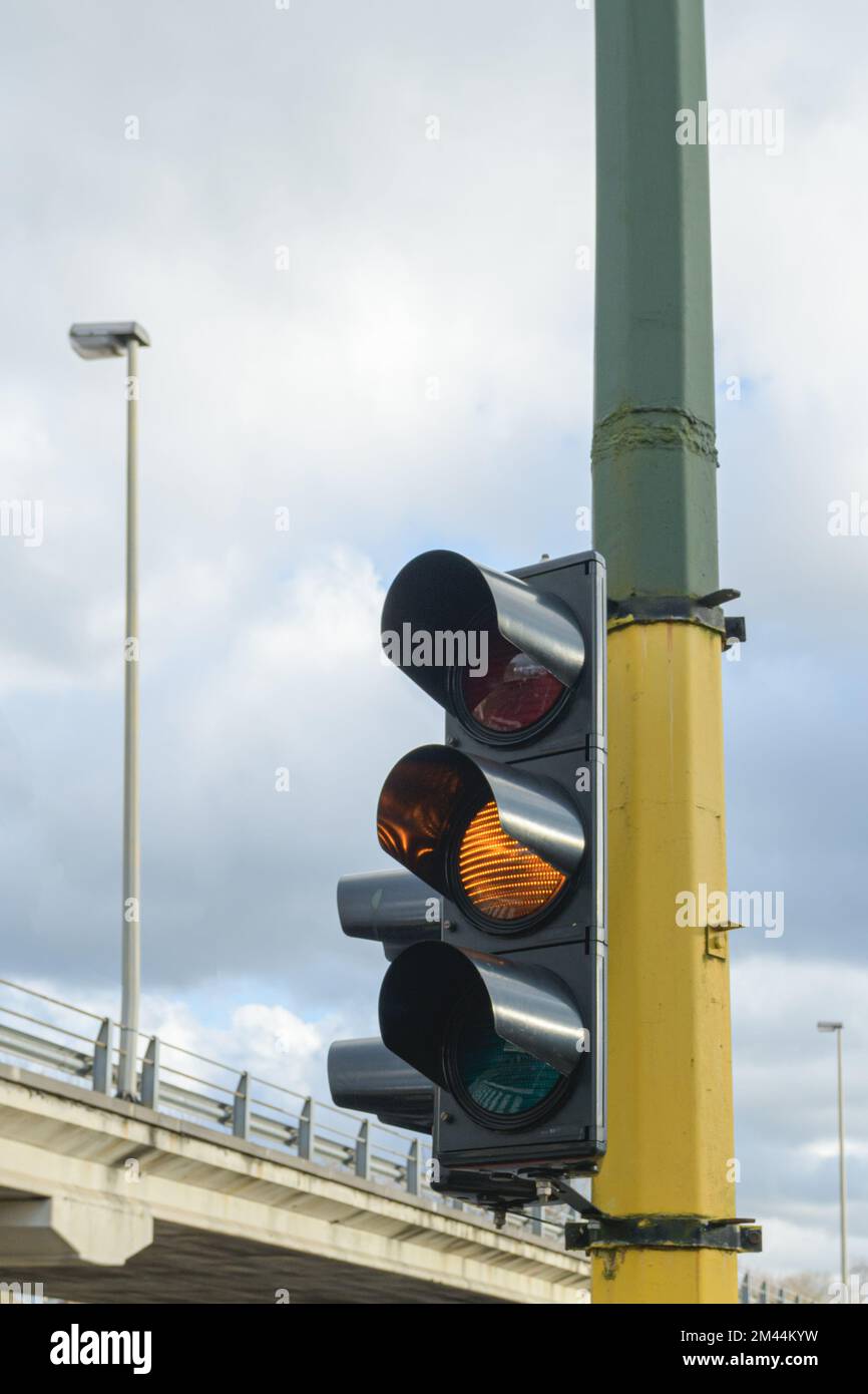 Yellow traffic light in the city. Against the blue sky Stock Photo