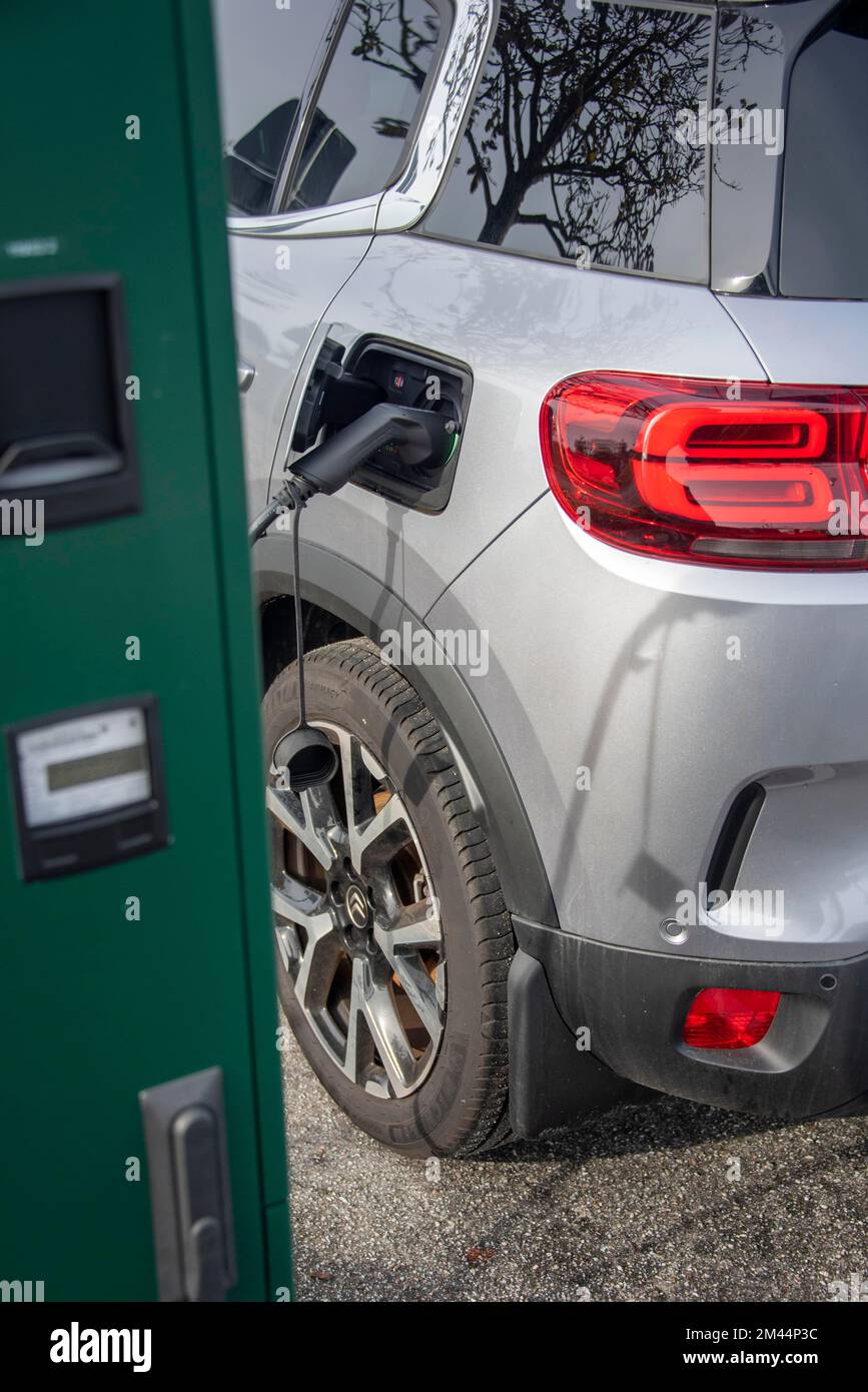 Car filling up with electricity, electric charging station, echarging