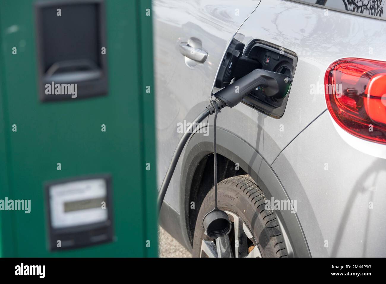 Car filling up with electricity, electric charging station, echarging