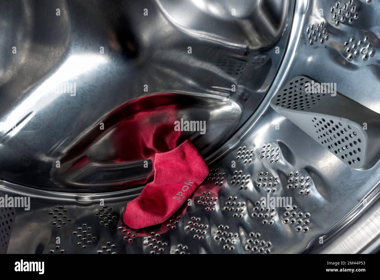 Single red sock, sports sock, lost, missing, in drum of