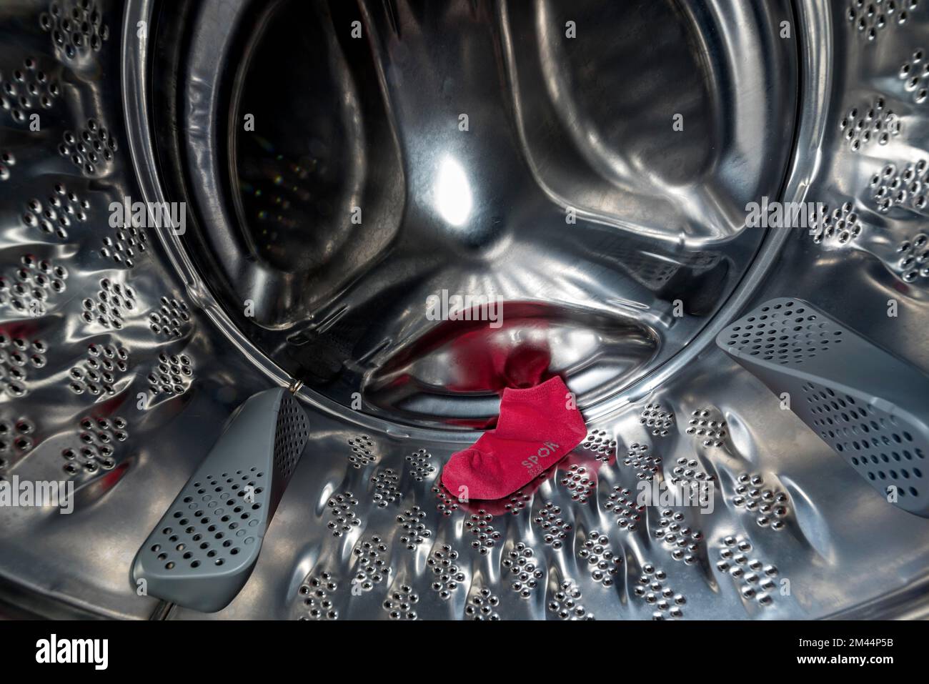 Single red sock, sports sock, lost, missing, in drum of