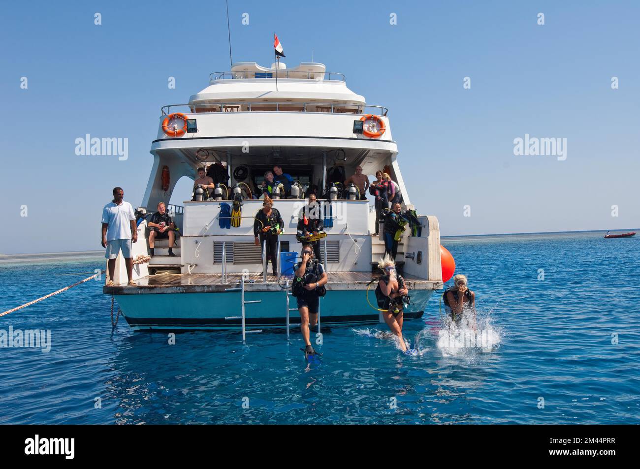 Divers make jump from dive platform of dive boat into water Sea, Red Sea, Egypt Stock Photo