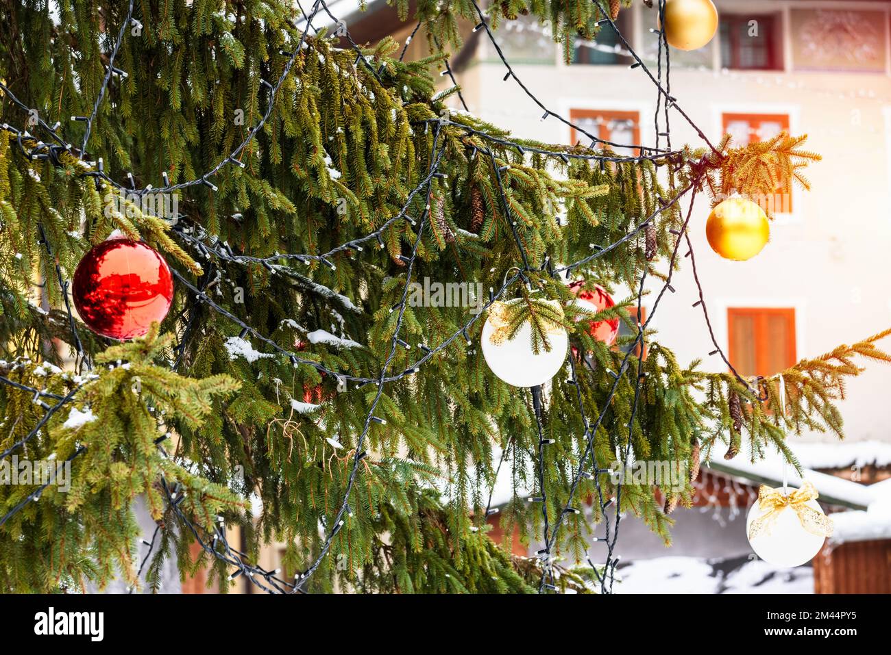Detail of an outdoor Christmas tree in a mountain village on a sunny day Stock Photo