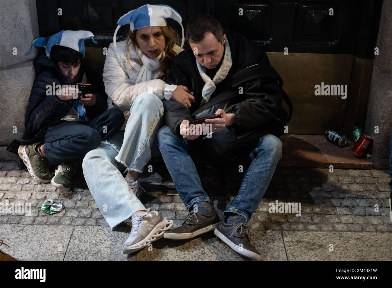 Madrid, Spain. 18th Dec, 2022. Argentinian fans watching the final match between Argentina and France on their mobiles. Argentina won the FIFA World Cup Qatar 2022 defeating France on a match that ended in a 3-3 draw, winning the championship title after penalties (4-2). Credit: Marcos del Mazo/Alamy Live News Stock Photo