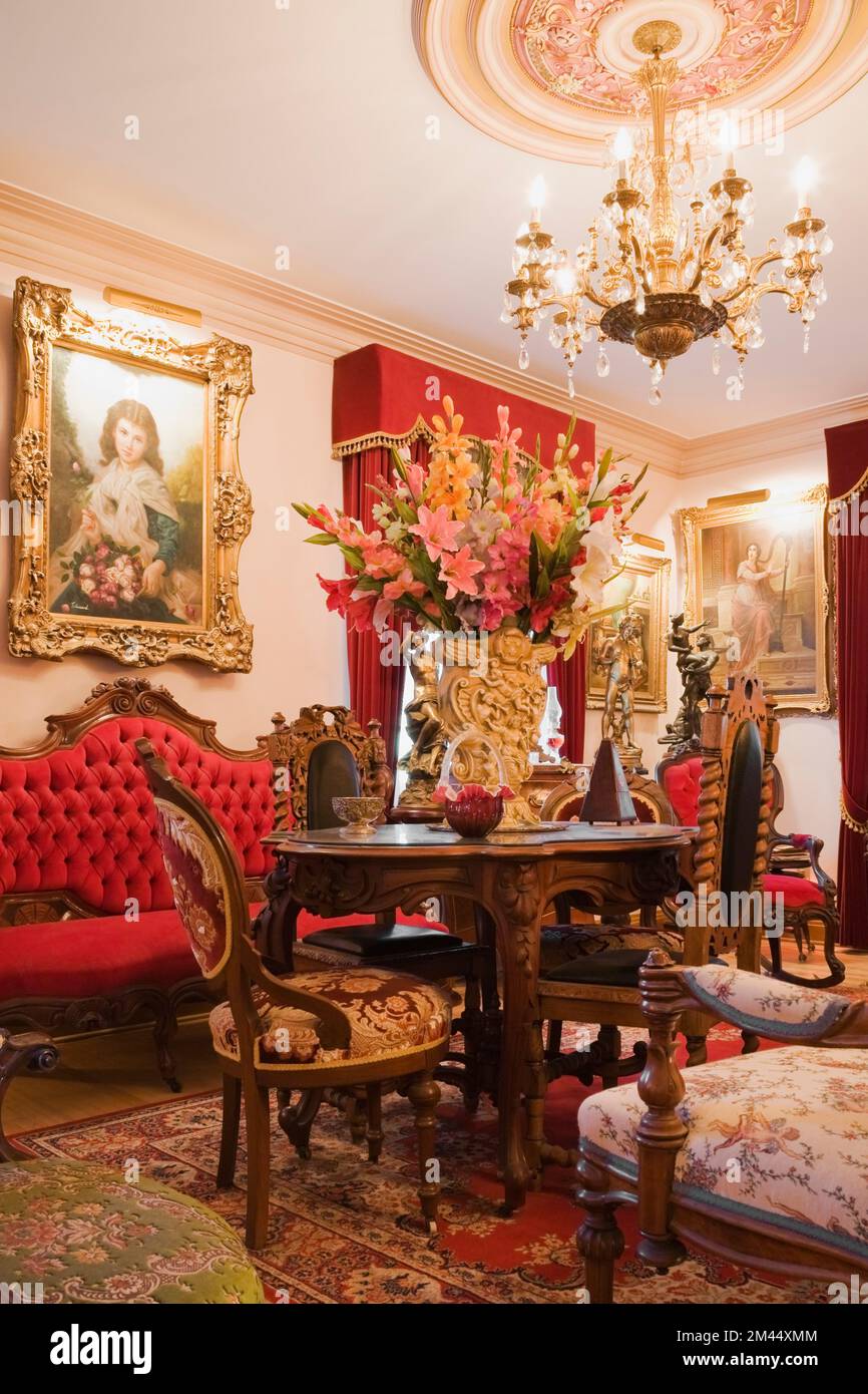 Antique furniture and furnishings adorn a living room inside a ...