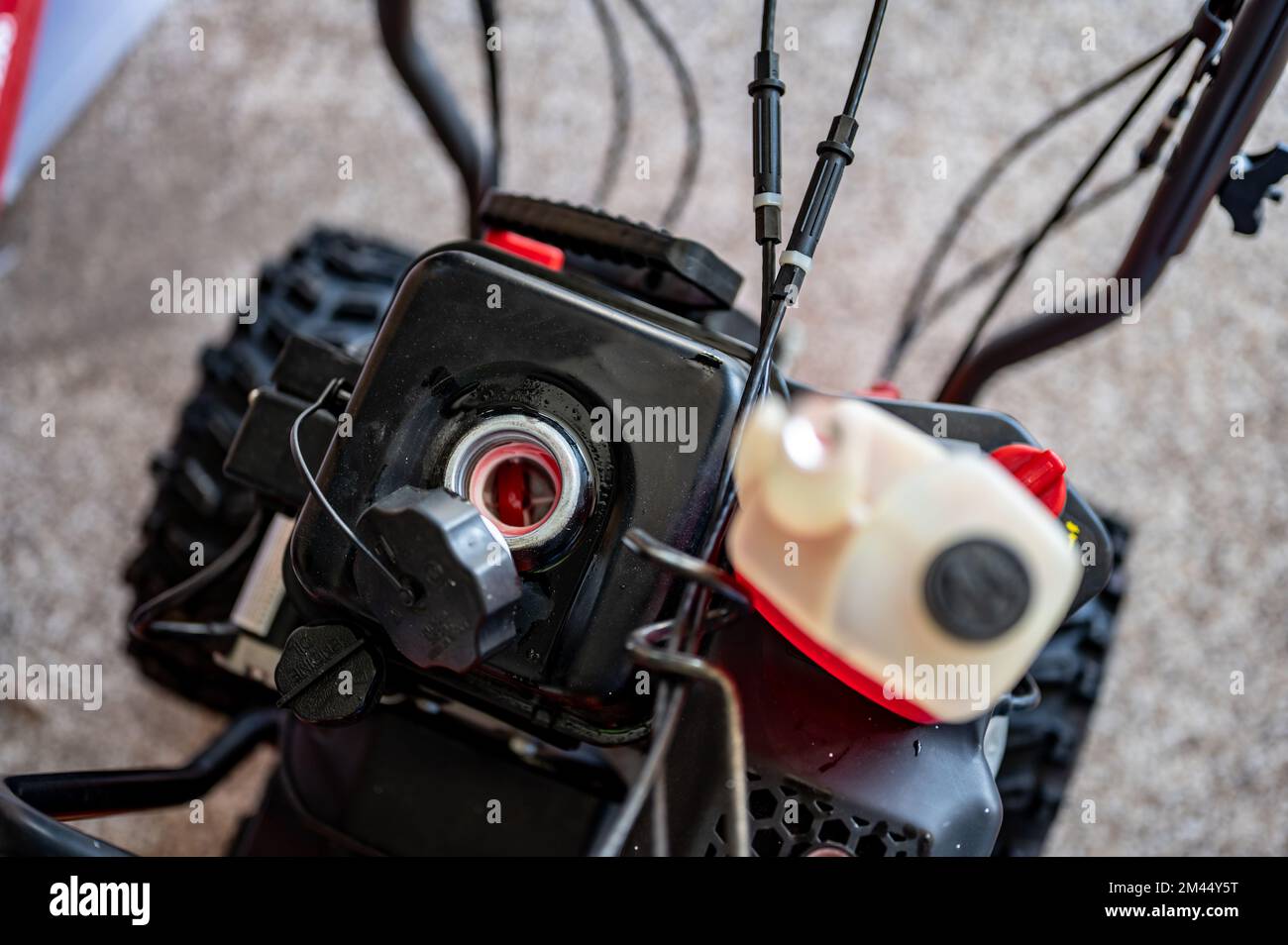 adding winter stabilizer fuel additive to a snow blower gas tank Stock