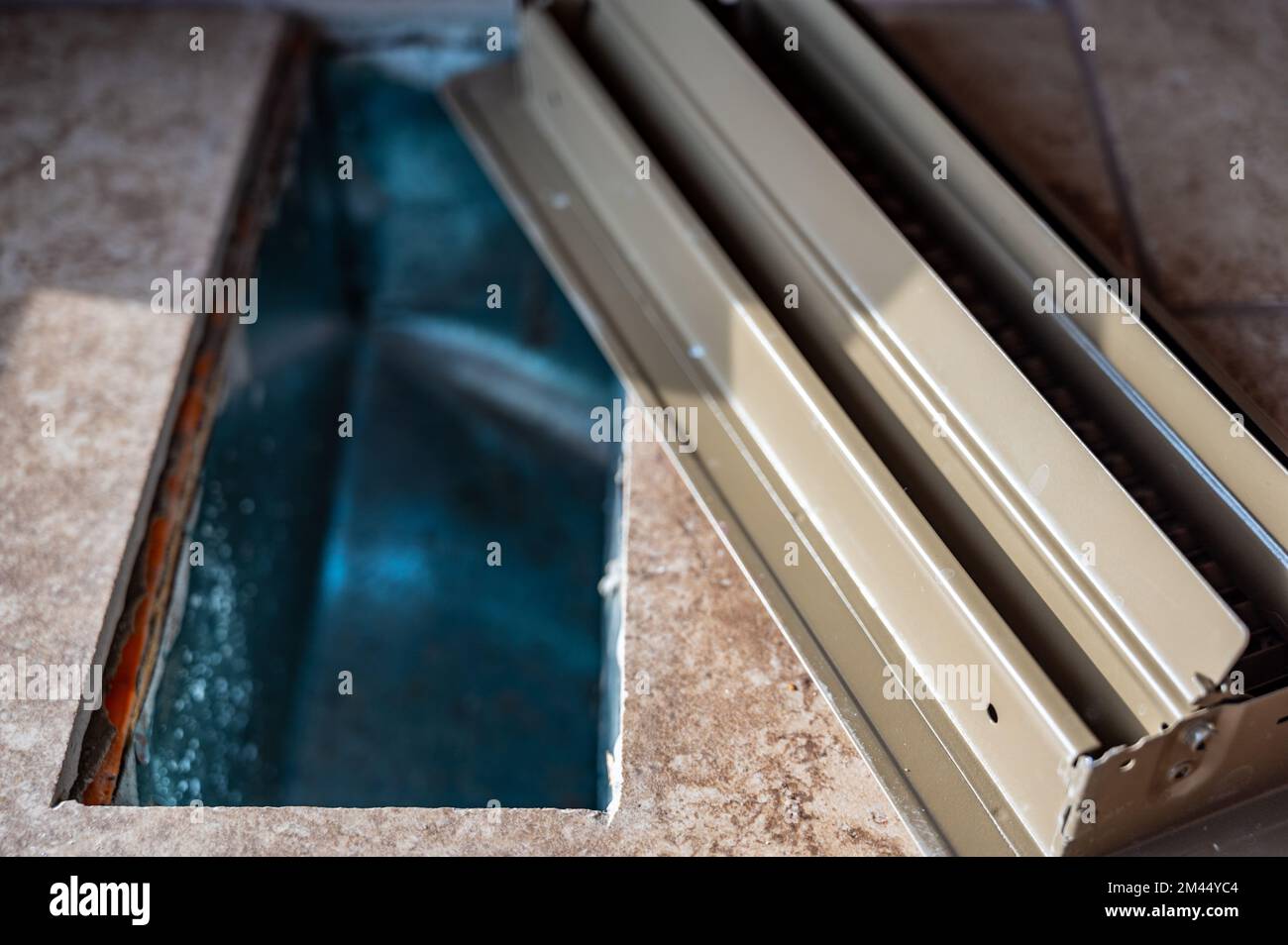 tiled open floor vent with cover removed Stock Photo