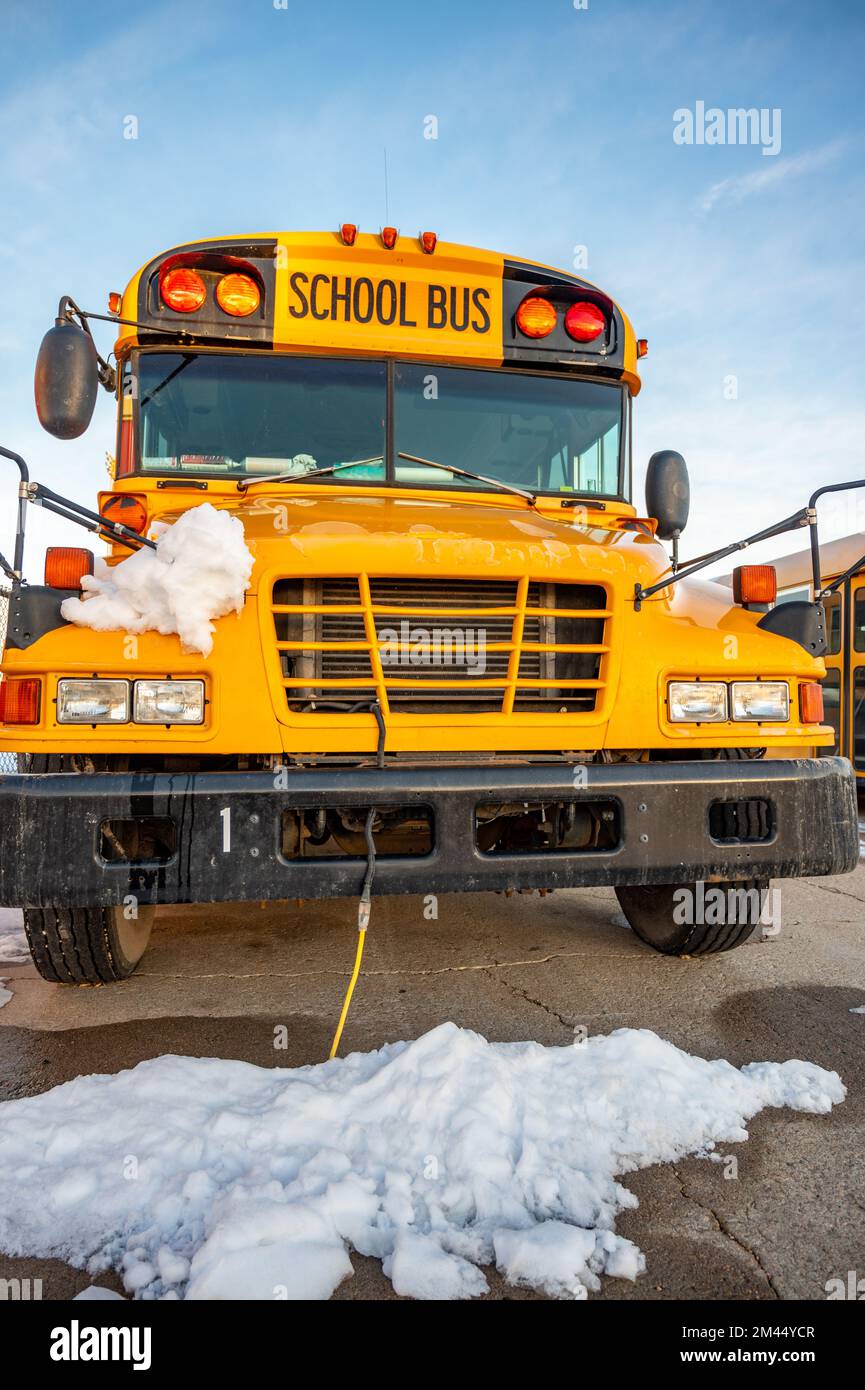 Power cord plugged into a vehicle engine heating block on a bus in a ...