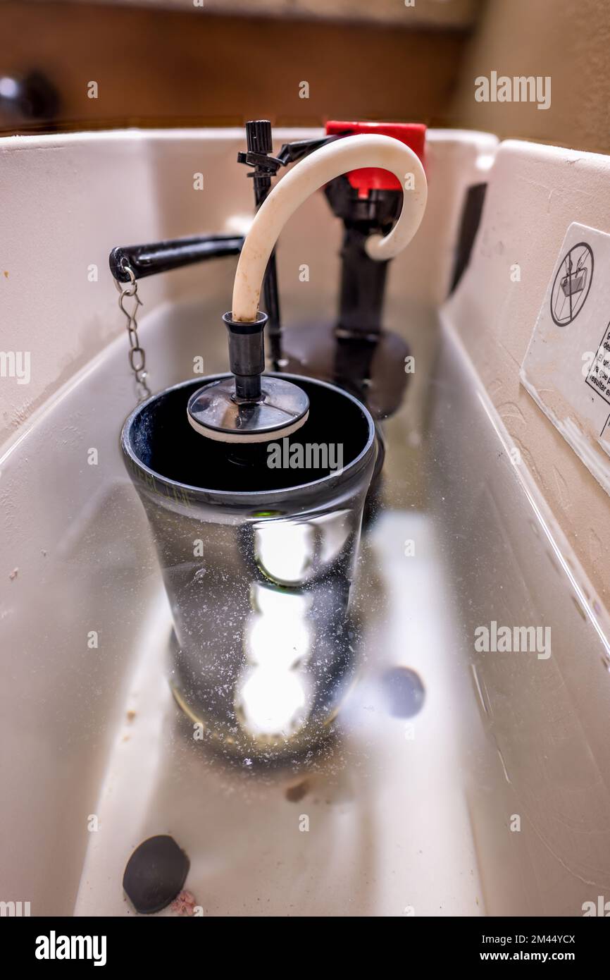Inside water tank of toilet with float raised Stock Photo