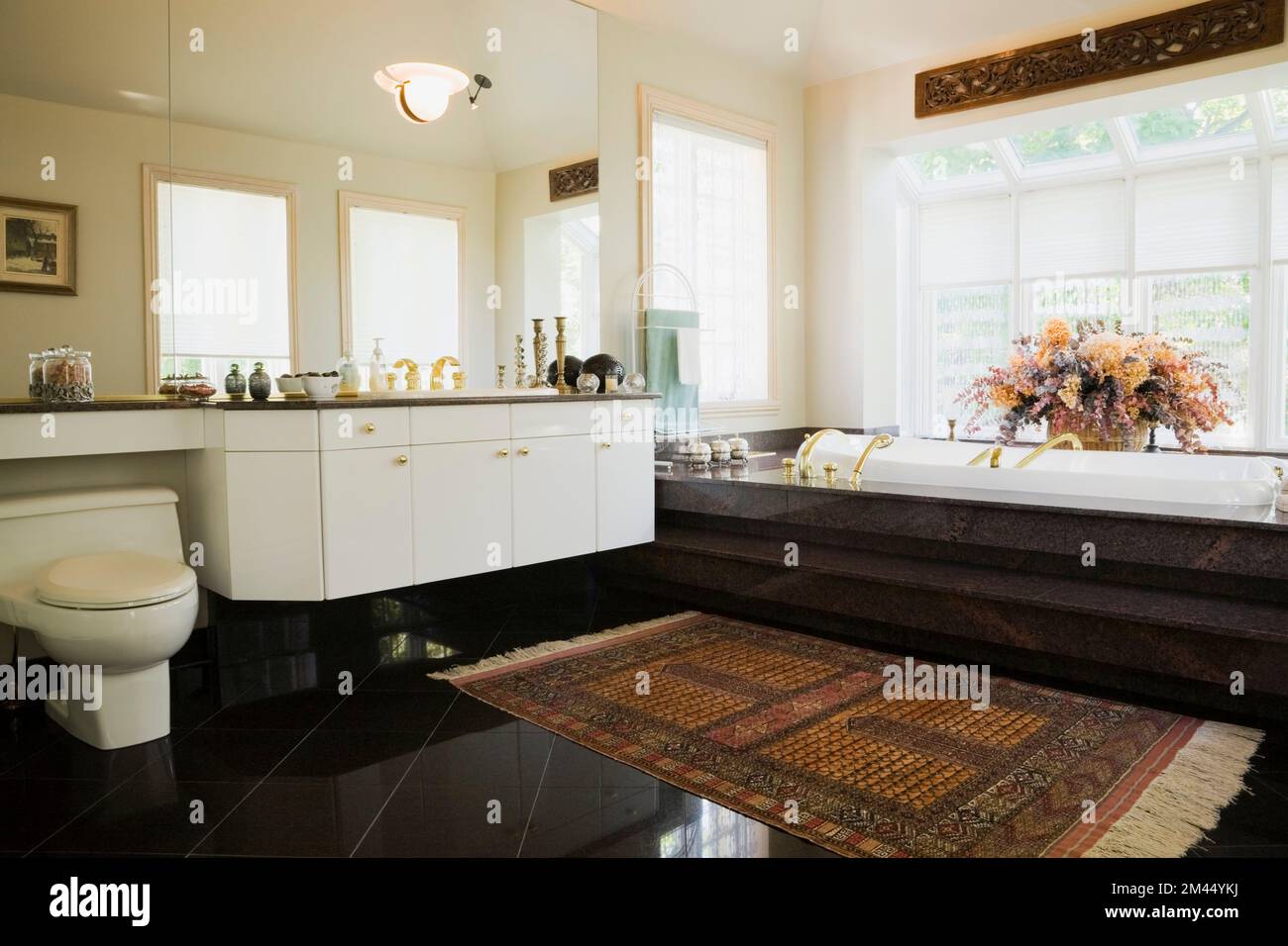 White lacquered vanity and encased bathtub in Moroccan style decorated