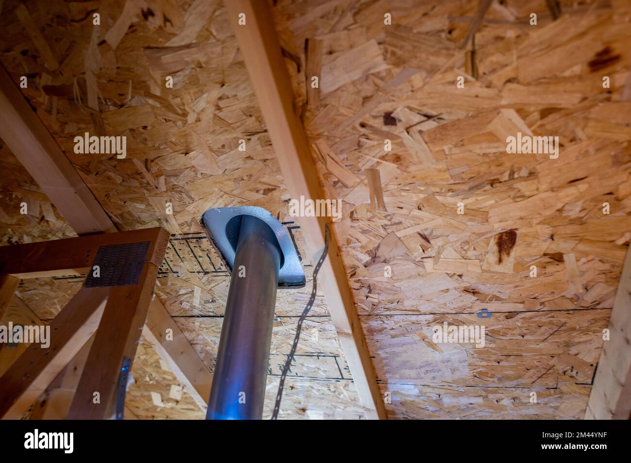 roof vent pipe seen from the attic with flashing for a weather seal