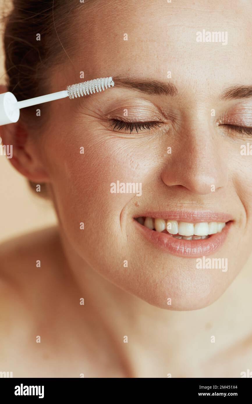 smiling young woman with brow brush. Stock Photo