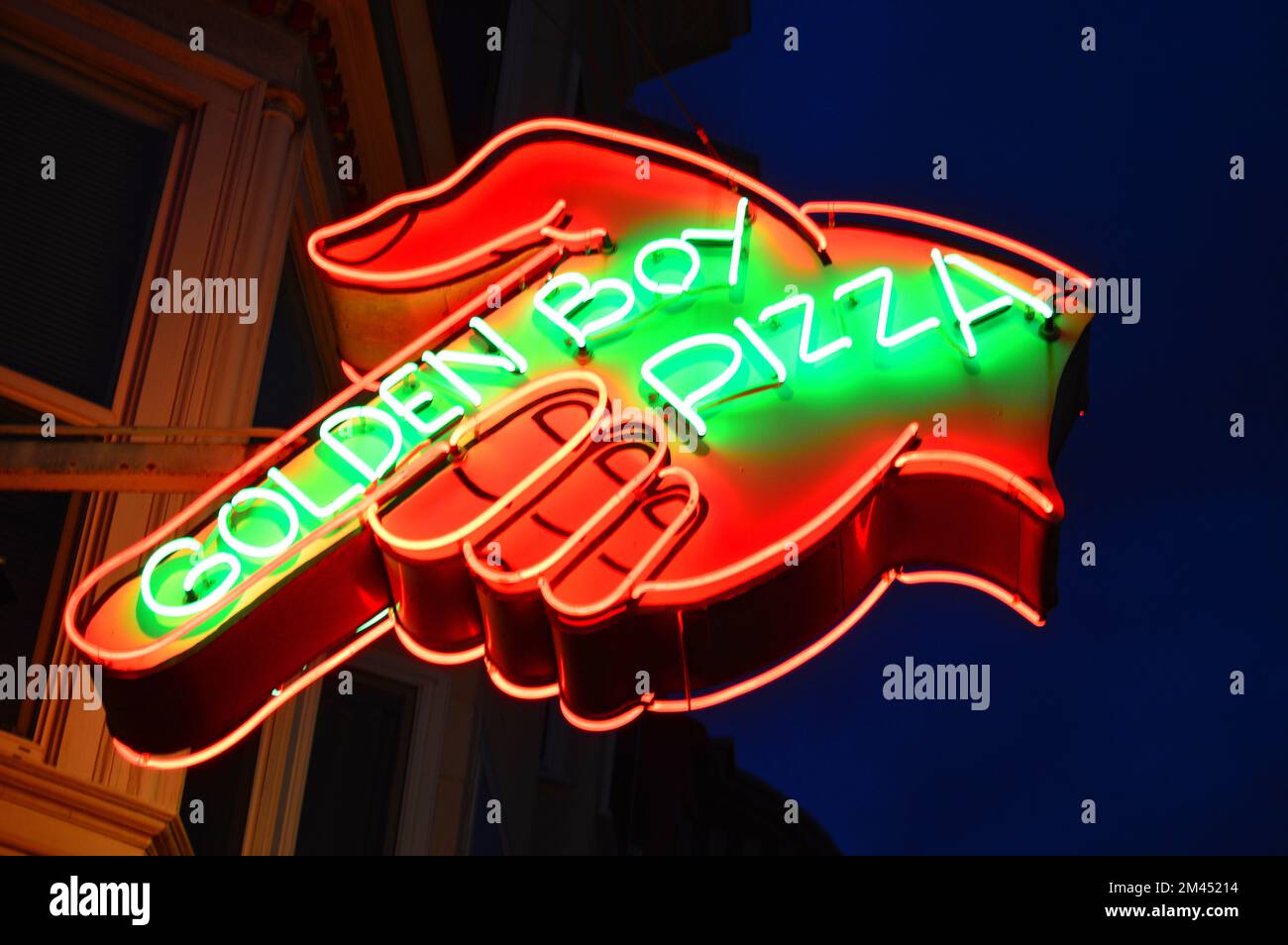 A neon hand points to Golden Boy Pizza in San Francisco's Italian North
