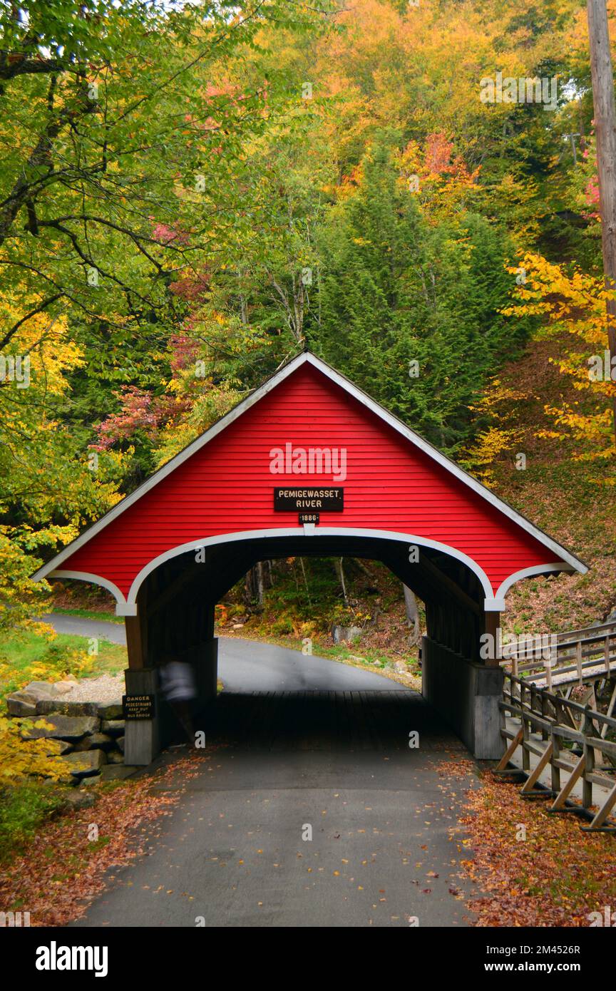 A quaint covered bridge crosses over the Pemigewasset River at ...