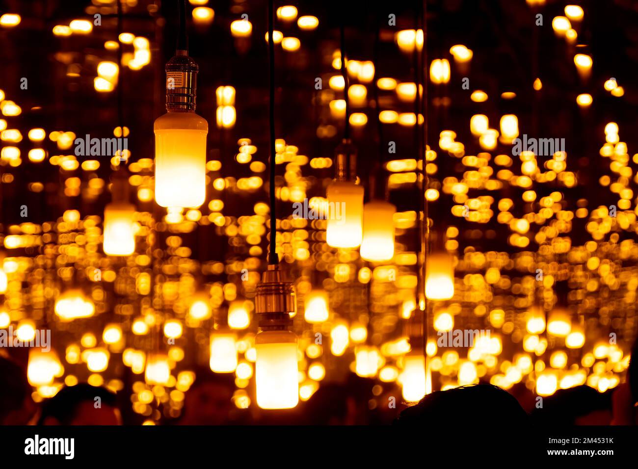 many lighted candles lit with mirrors reflecting the light throughout