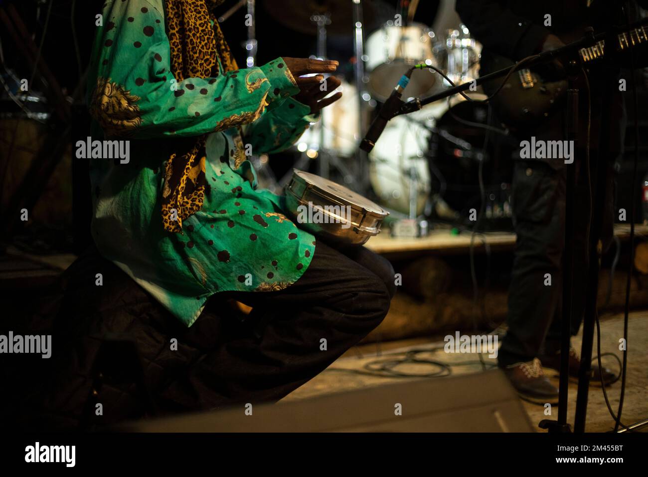 African plays drum. Reggae band performance. Playing there. Details of