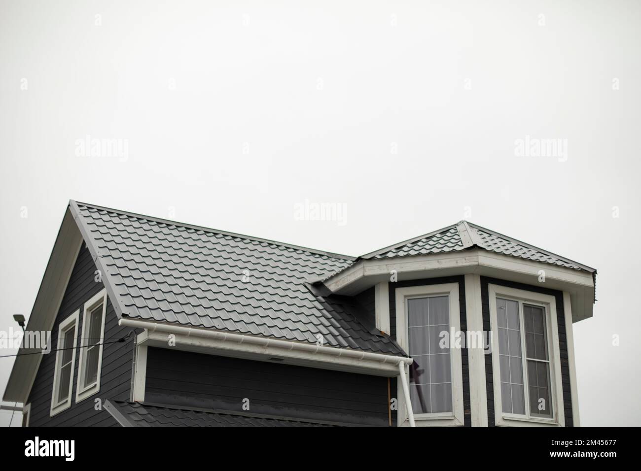 New roof of house. Country house in village. Ridge roof. Stingray on ...