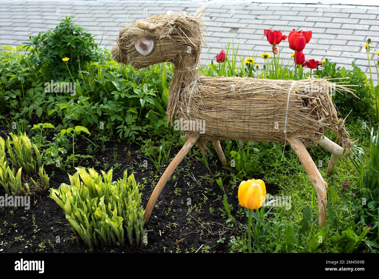 Figure of horse in garden. Figure of hay in park. Details of flower bed