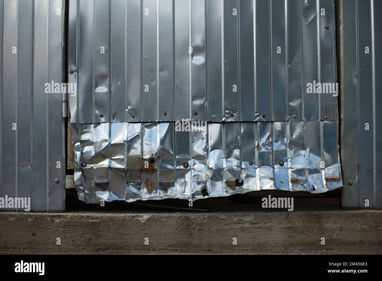 Crumpled metal. Broken door. Steel profile broken. Damaged wall Stock Photo Alamy