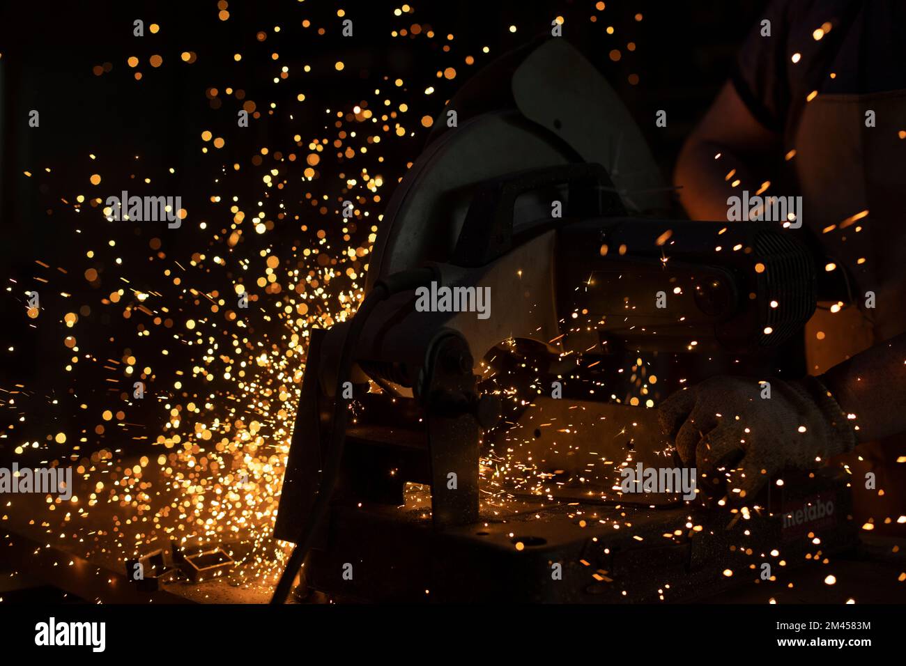 Sparks from welding. Metal cutting. Production details. Industrial background. Stock Photo