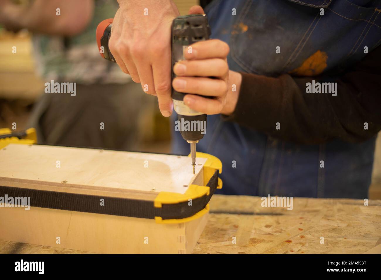 Hand holds box. Guy creates box out of wood. Work in workshop. Wood ...