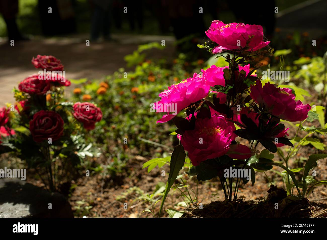 Flowers on grave. Artificial flowers at funerals. Mourning ceremony
