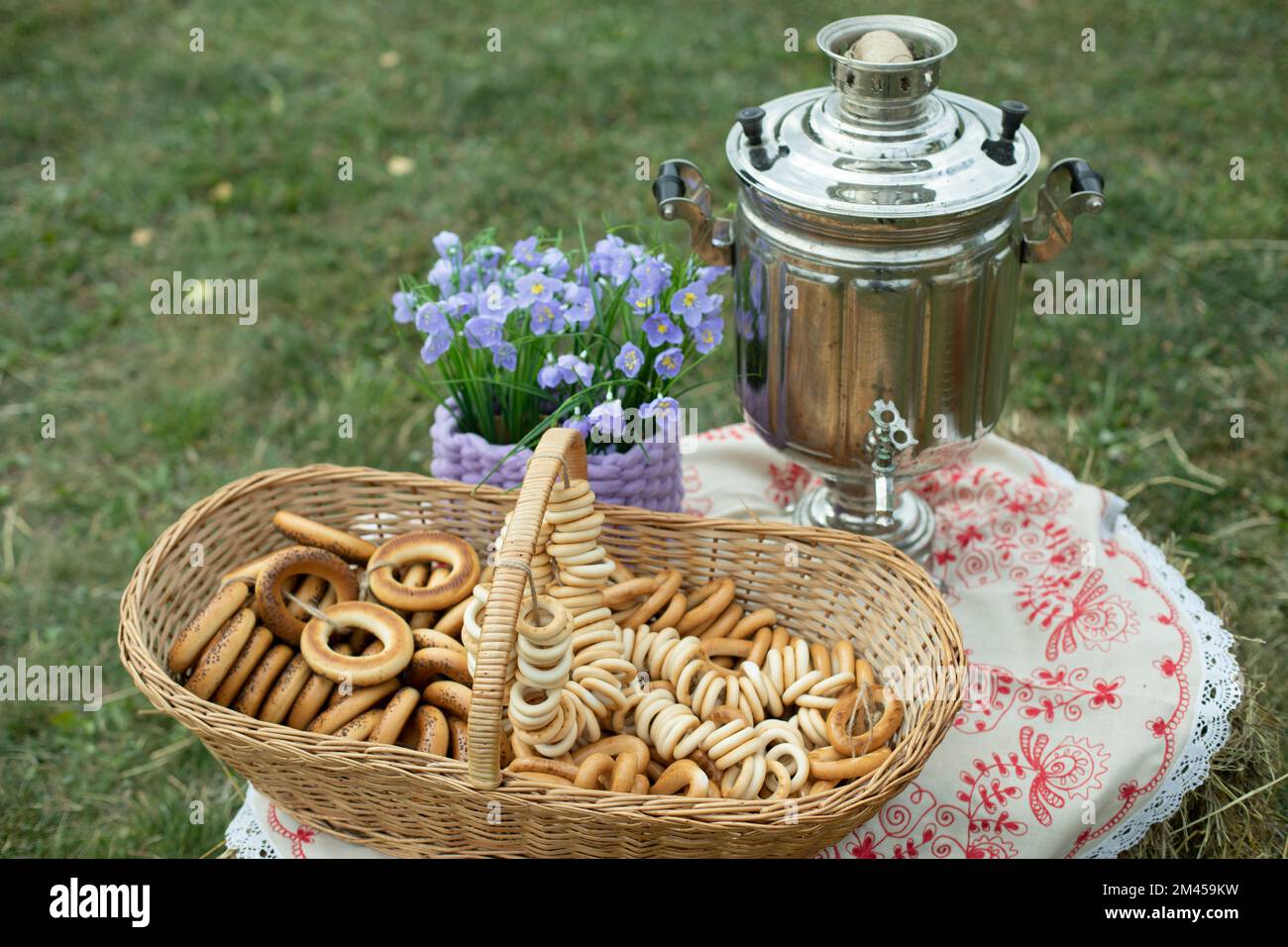 Russian treats. Sweetness from flour. Basket of dry stems. Steel kettle