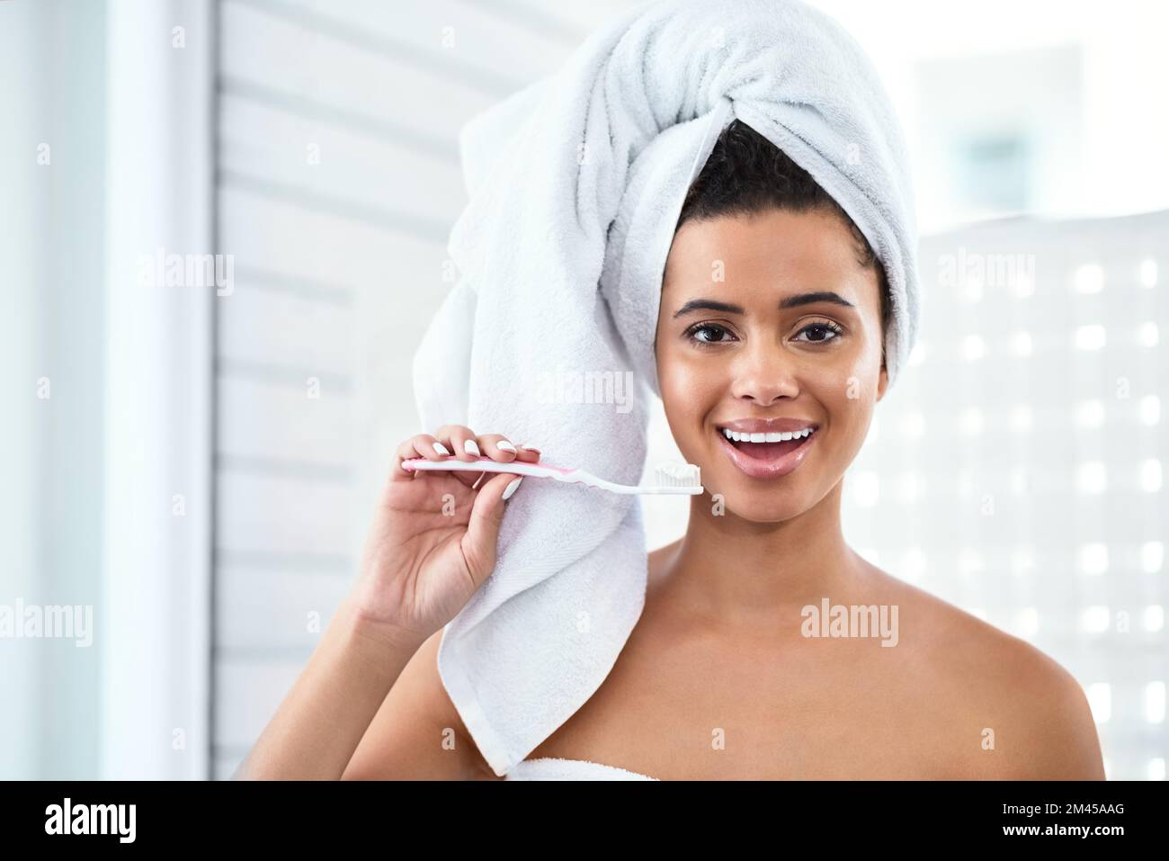 Theres no excuse not to brush to brush your teeth. a beautiful young woman brushing her teeth at home. Stock Photo