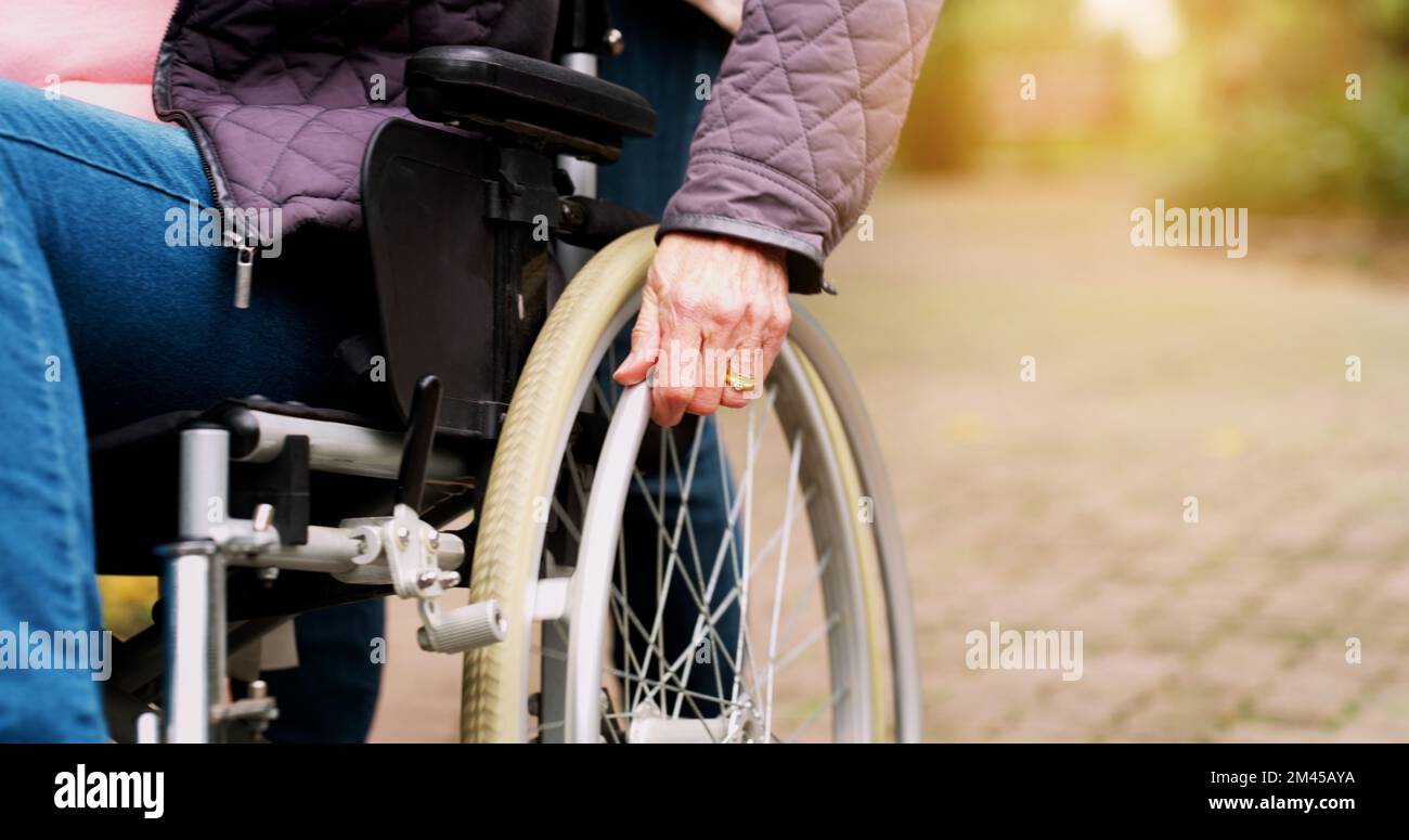 The wheels keep on turning. an unrecognizable elderly woman in a