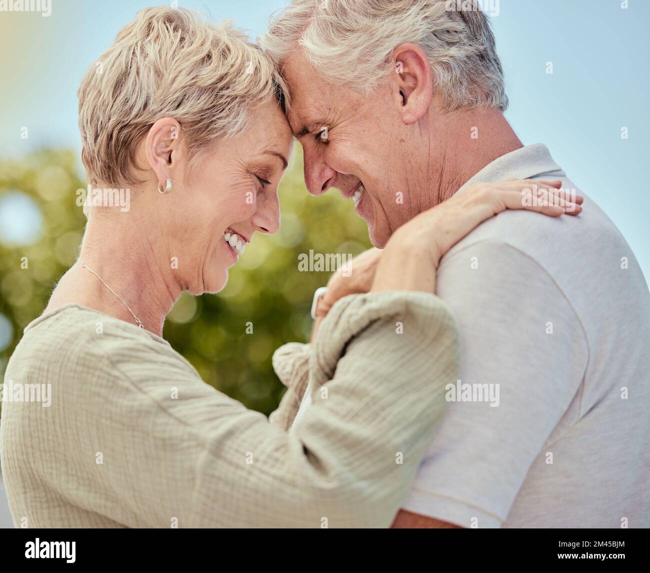 Hug, elderly and couple with love and trust in marriage, retirement and quality time outdoor, park with nature and commitment. Life partner, care and Stock Photo