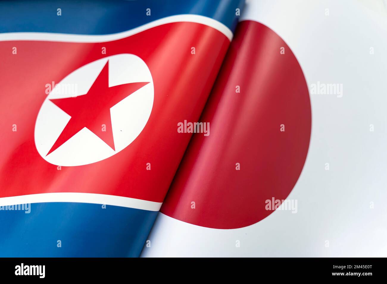 Background of the flags of the north korea and Japan. The concept of interaction or counteraction between the two countries. International relations. Stock Photo
