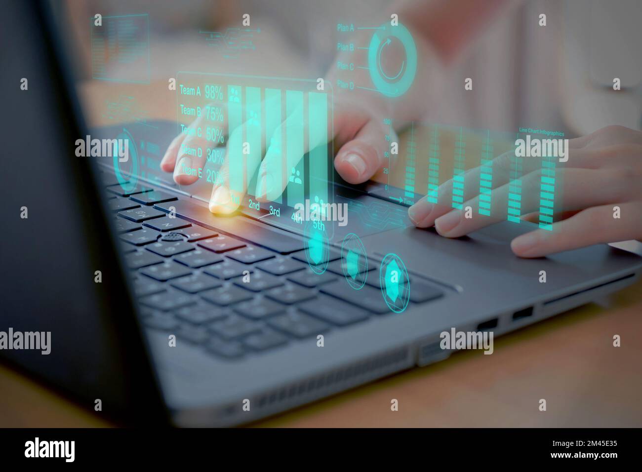 Woman using laptop analyzing and development at various information on futuristic virtual interface screen. Stock Photo