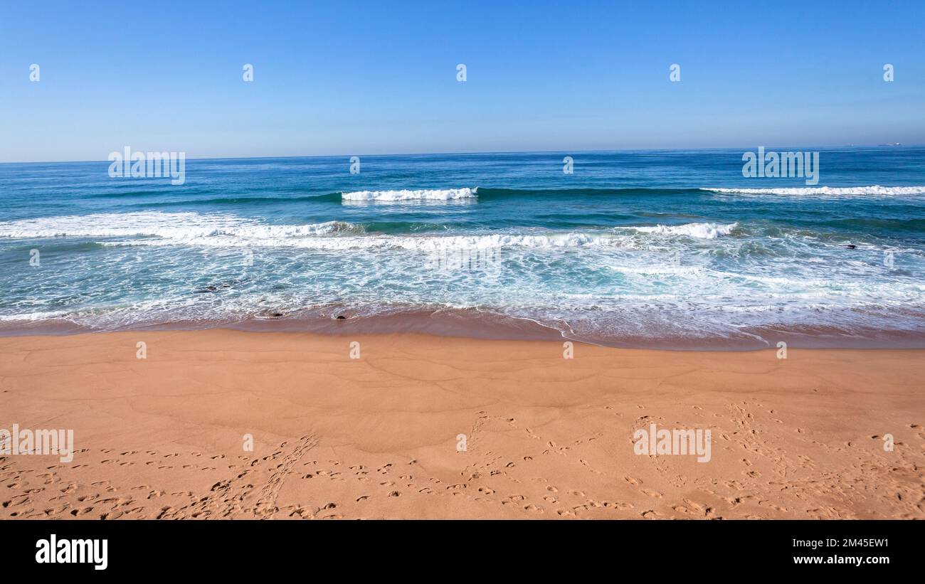 Beach coastline a scenic waters edge blue ocean calm flat sea horizon landscape blue ocean calm flat sea horizon landscape. Stock Photo