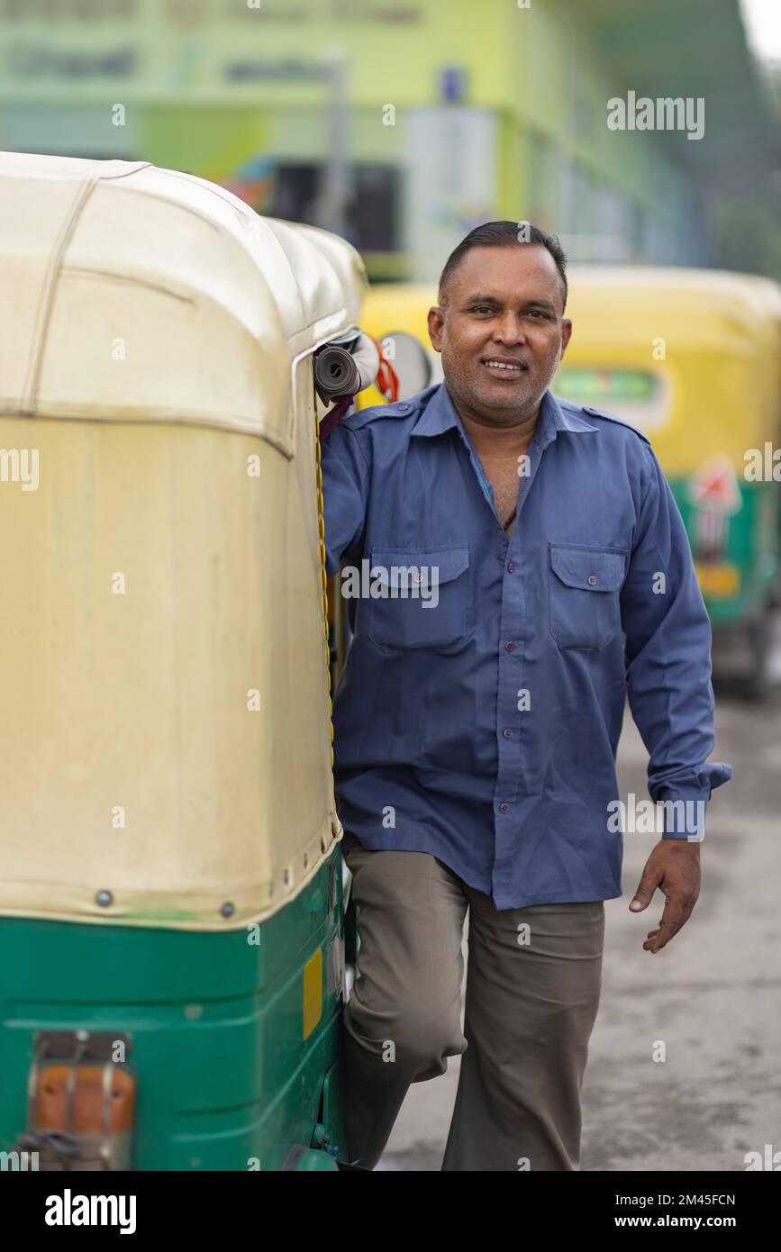 Portrait of an auto rickshaw driver standing in auto stand Stock Photo Alamy
