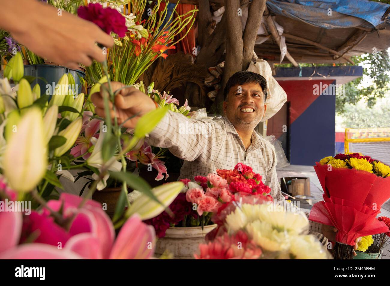 Male florist selling flower to a customer Stock Photo