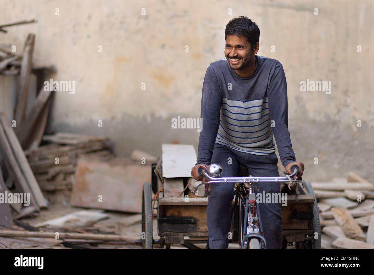 A Rickshaw puller taking away scrap Stock Photo - Alamy
