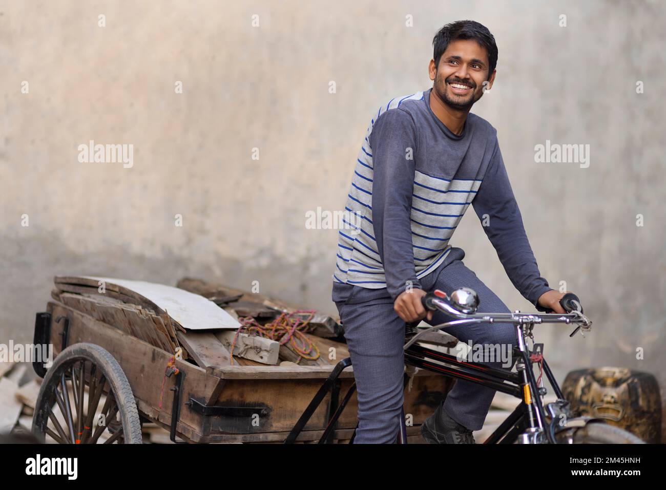 A Rickshaw puller taking away scrap Stock Photo - Alamy